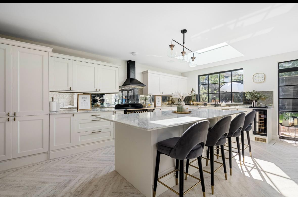 white kitchen design with marble accents. luxury kitchen design. south london construction